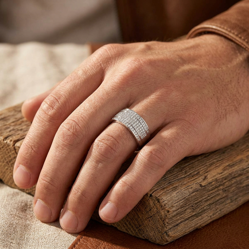 Full-hand lifestyle shot of a male model's hand with a 0.38 ct diamond band ring in white gold, resting on textured wood, highlighting the ring's delicate profile and craftsmanship.