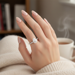 female hand model image, lifestyle setting scene. pear shaped center diamond is 8mm lenth x 6mm width, band is very sleek. make the ring smaller than it is, focus on pear shaped diamond detail