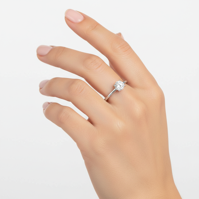 female hand model image studio soft light setting, solitaire round stone is 6.5mm diameter. make the ring smaller than it is