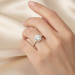 female hand model image, editorial setting scene. round halo diamond is 6mm. make the ring smaller than it is