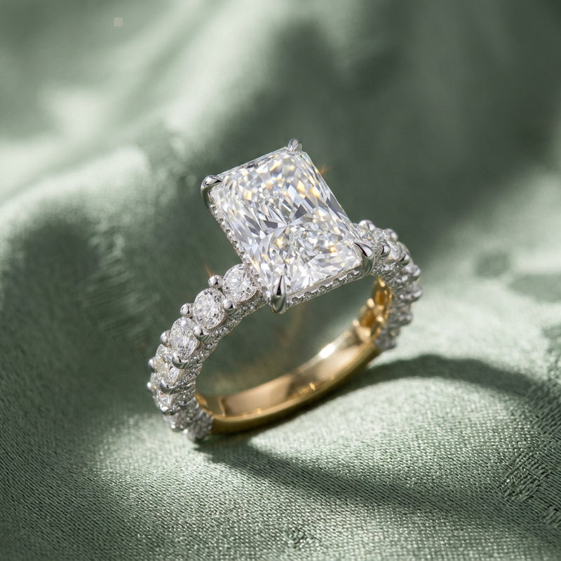 Artistic high-resolution image of Maelis engagement ring on textured sage green fabric, showcasing micro-details and radiant cut brilliance.