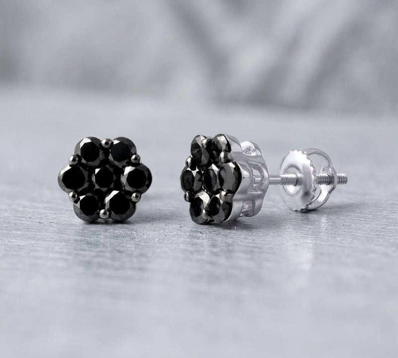 Close-up of 1.1ct black diamond cluster studs in 10K white gold, highlighting their intricate design and sparkling diamonds with soft natural lighting.