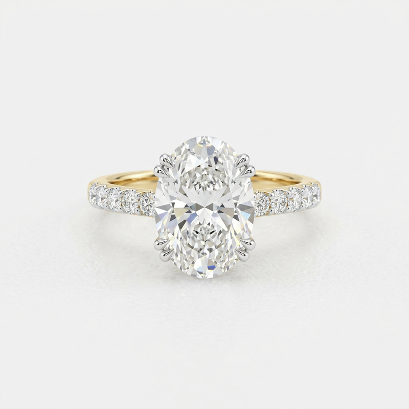 Front top view of Isidora 14K yellow gold oval lab-grown diamond engagement ring with hidden halo on white background.