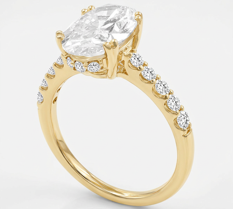Slant view of yellow gold Isidora engagement ring with lab grown diamond, white background.