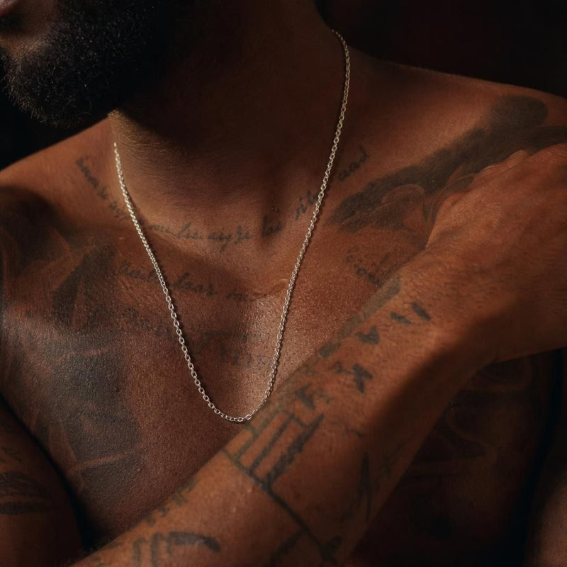Detailed close-up of a 24-inch Italian-made 925 sterling silver diamond-cut cable chain necklace on skin.