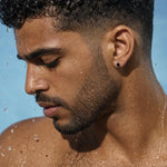 Side profile of a model showcasing Yami black spinel stud earrings set in 925 sterling silver on a wet earlobe.