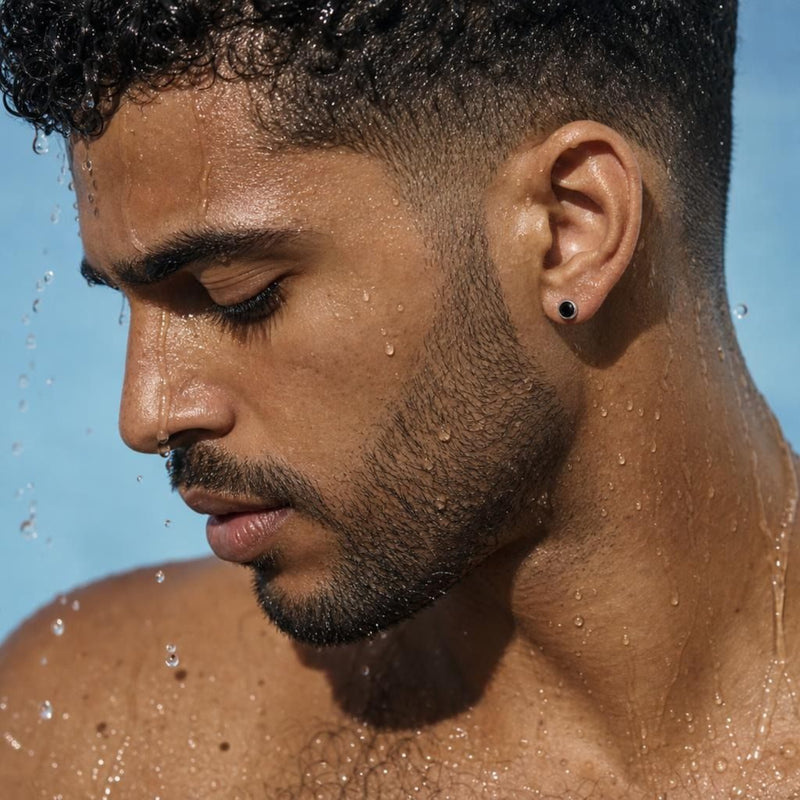 Side profile of a model showcasing Yami black spinel stud earrings set in 925 sterling silver on a wet earlobe.