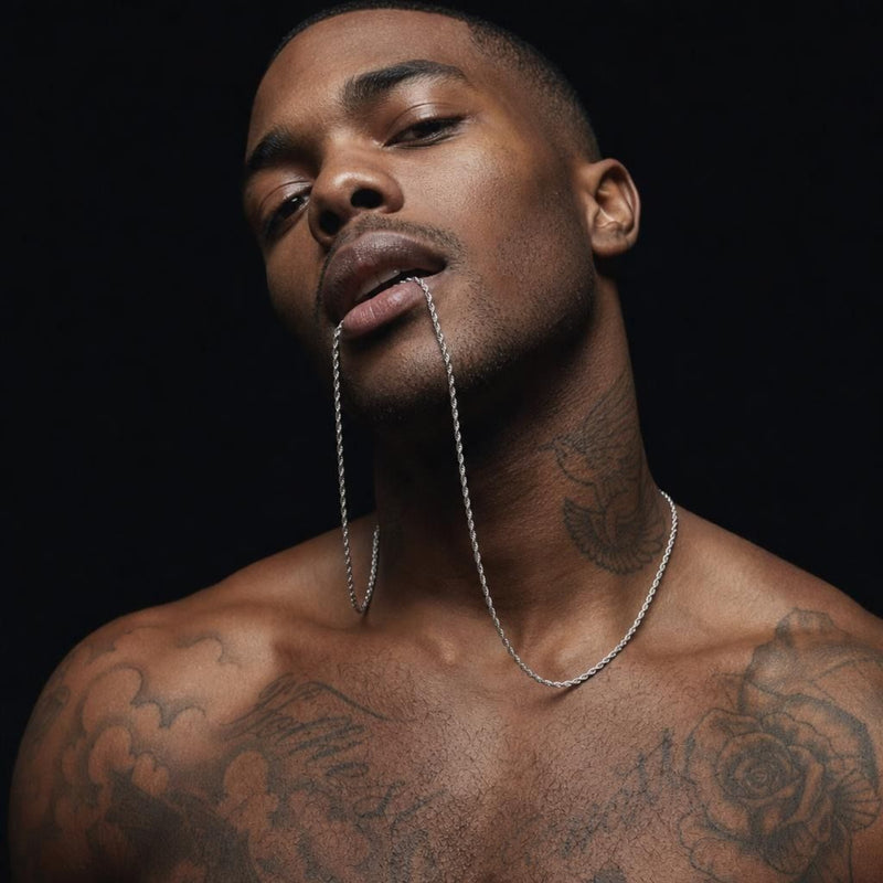 Close-up portrait of a man wearing a 925 sterling silver rope chain necklace against a dark background.